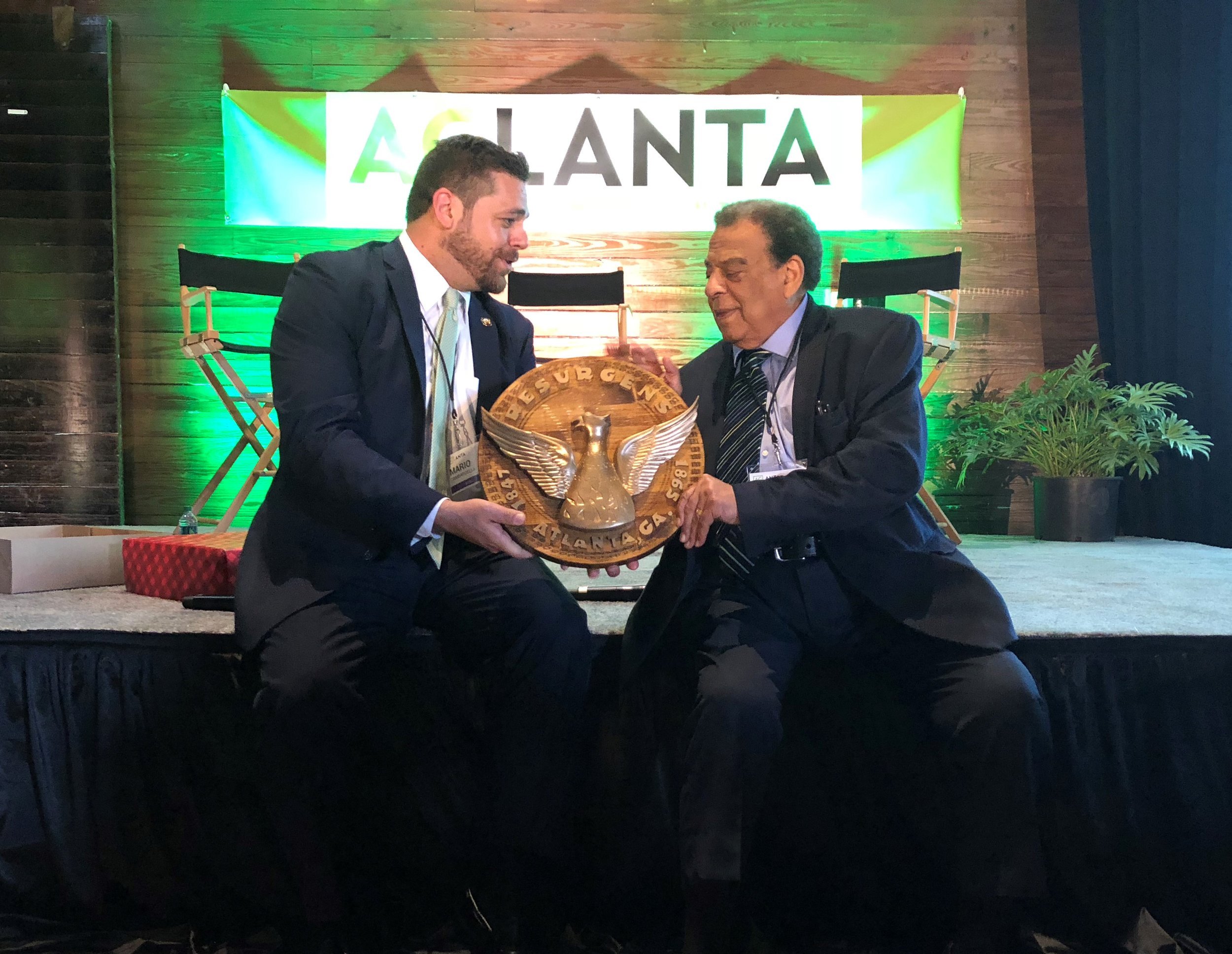 Atlanta's Director of Urban Agriculture, Mario Cambardella (left), presents the Seal of Atlanta to Ambassador Andrew Young (right), to honor his dedication to urban agriculture and resilience.