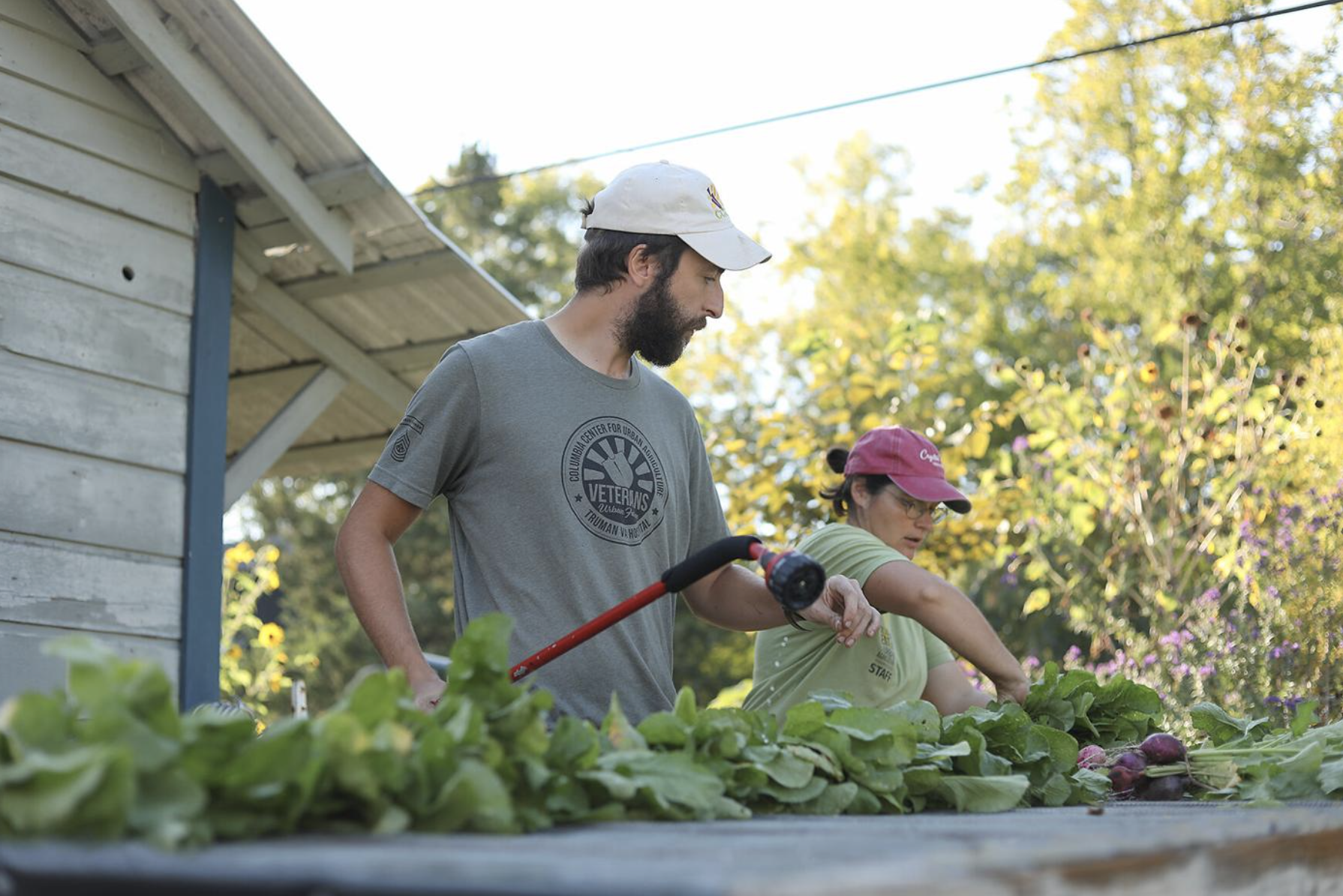 AmeriCorps VISTA employee Graham Bellairs, left, and Columbia Center for Urban Agriculture employee Carrie Hargrove wash radishes Tuesday at the Veterans Urban Farm in Columbia.“I worked here last spring with a team of nine other people,” Bellairs said. “My girlfriend, who works at another location, and I liked the area so much we said ‘hey, can we stick around and do some more work with y’all?’”