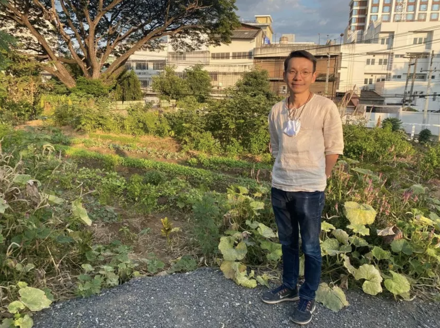 Supawut Boonmahathanakorn stands by the urban farm he helped create; Image: Thomson Reuters Foundation/Rina Chandran