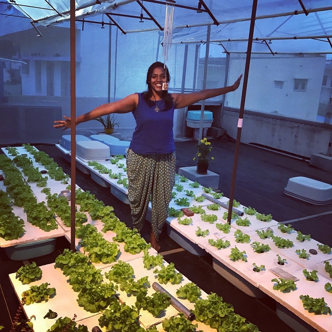 Ann Vinya in her greenhouse.
