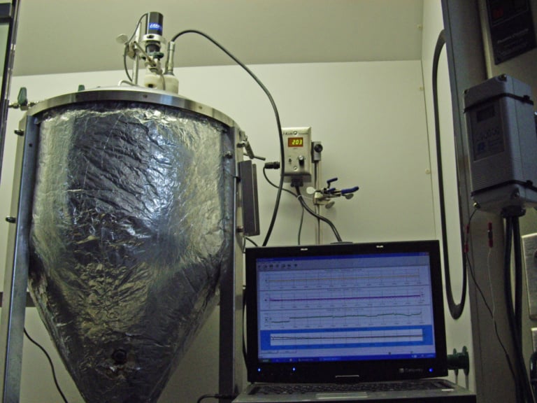 An anaerobic bioreactor is used as the first stage in a two-stage process toward organic ammonium nitrate production by breaking down protein-bound nitrogen to ammonia with hyper-ammonia-producing bacteria.