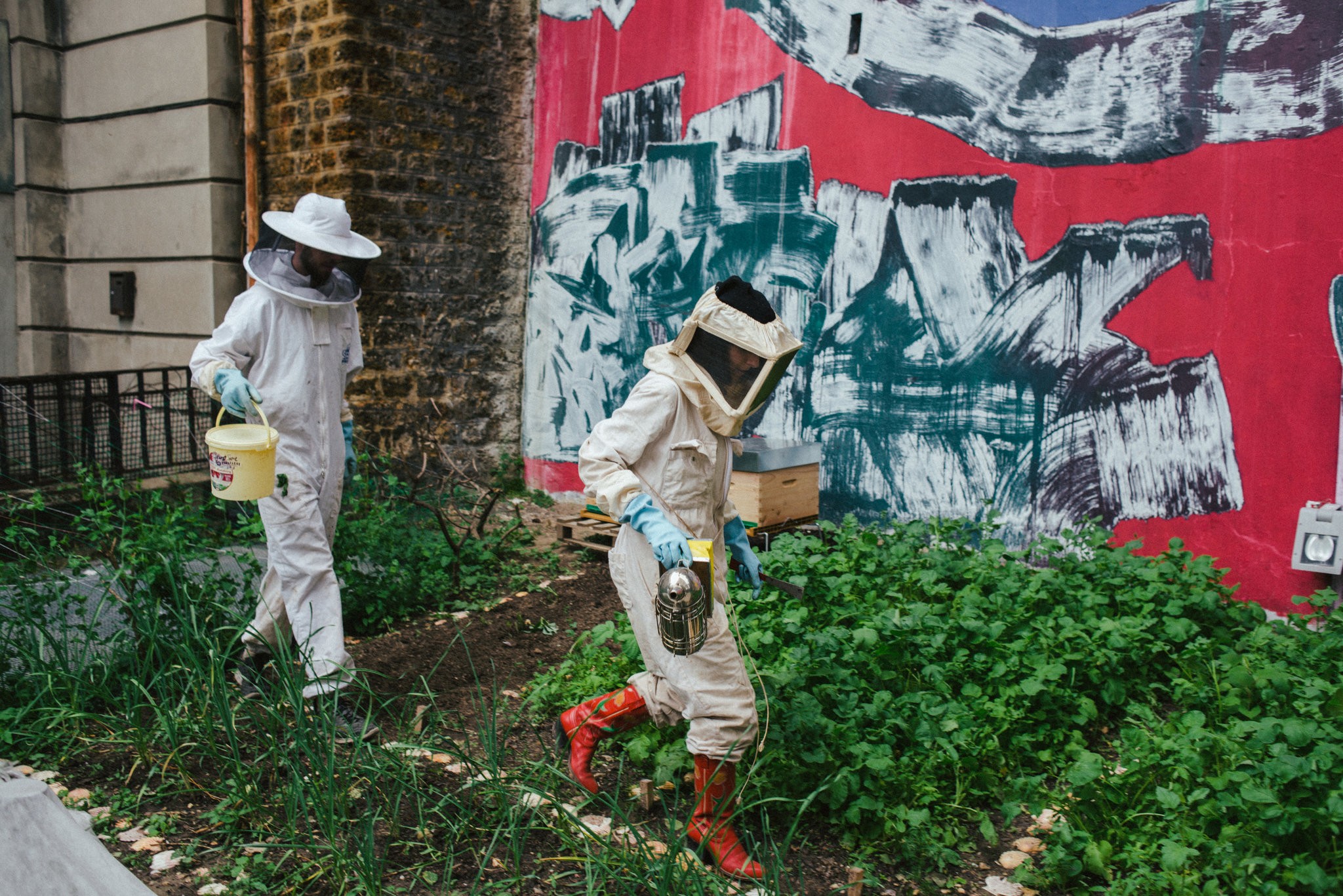  Jason Beliveau, left, sous chef at Les Grands Verres restaurant at the Palais de Tokyo museum and Ms. Lozoff, a beekeeper, working at the museum’s vegetable garden.   
